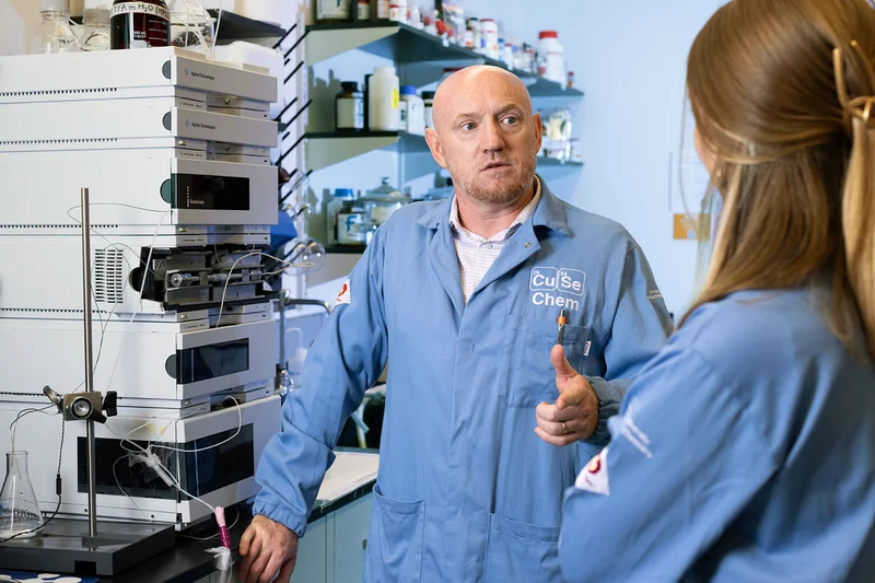 robert doyle and a student talking in lab coats