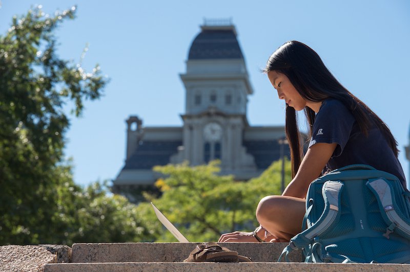 a student studying in front of the hall of languages