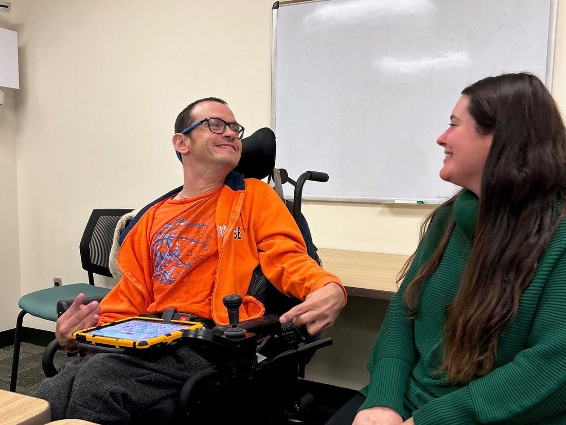 Two people seated next to one another.