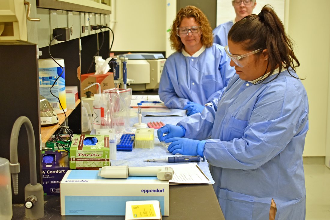 Caitlyn Taveira (right) from the Nassau County Division of Forensic Sciences performing manual sequencing library preparation with Kristen Becker (left) from the Erie County Central Police Services Forensic Lab looking on.