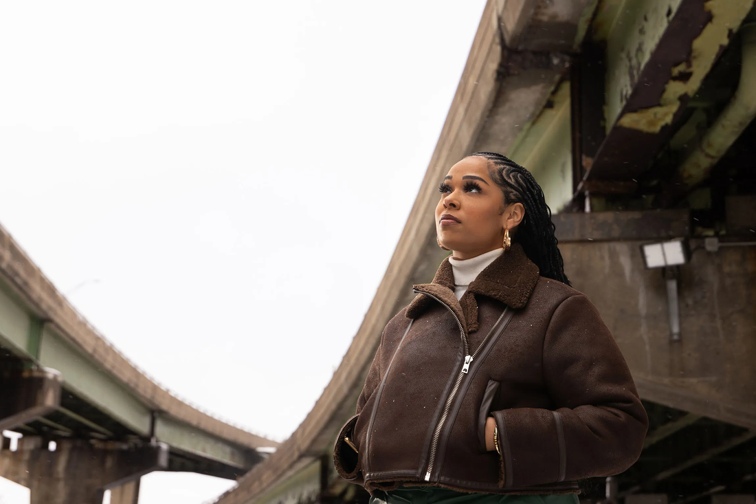 Person standing beneath two bridges.