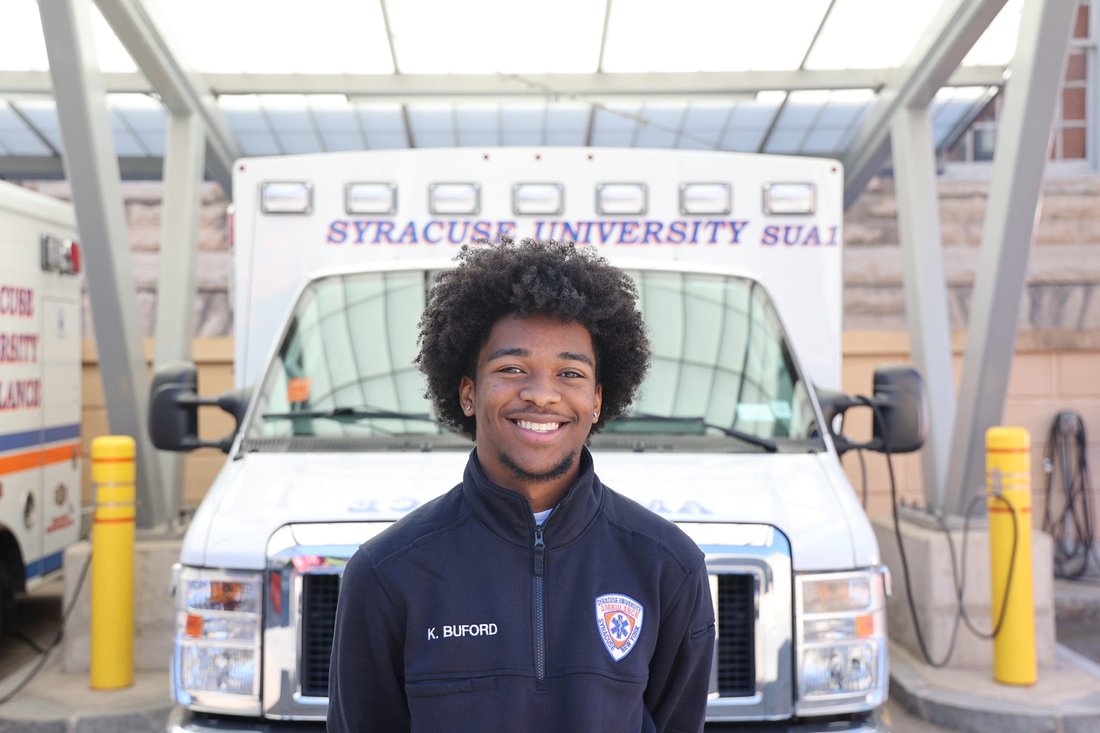 Man standing in front of an ambulance.