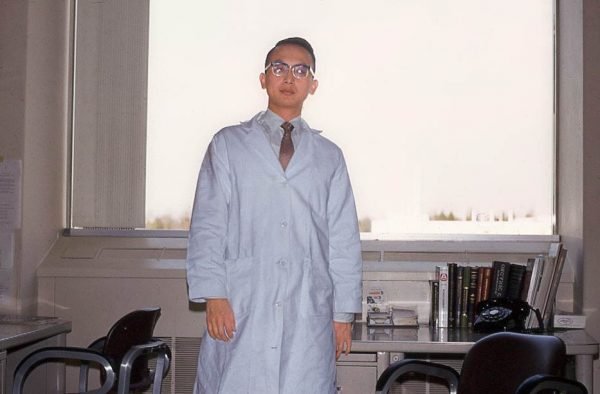 Person in a lab coat in a lab.