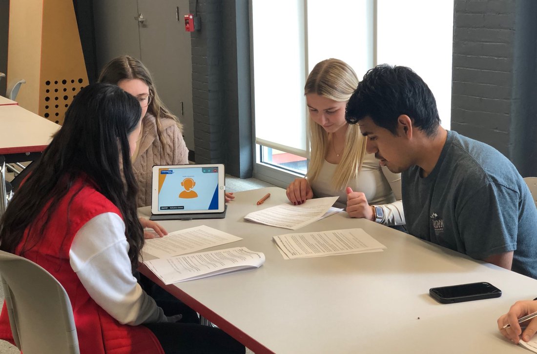 Students doing research at a desk.