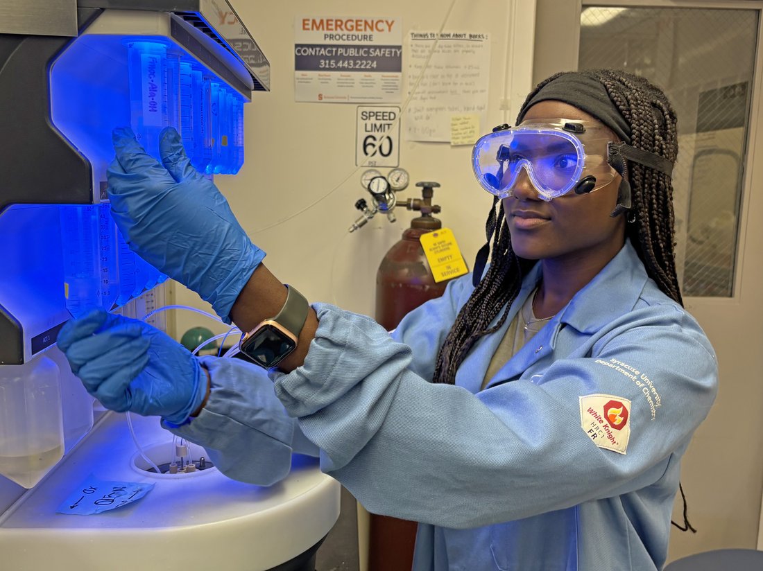 Person operating peptide synthesizer.