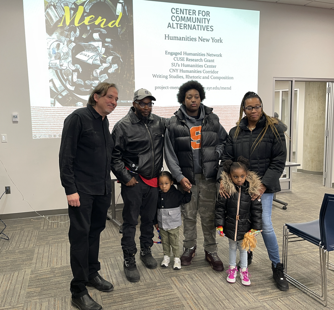 Group of people standing in front of a screen.