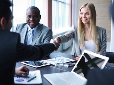 People shaking hands at a business meeting.