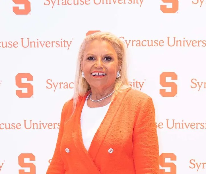 Woman standing in front of a Syracuse University backdrop.