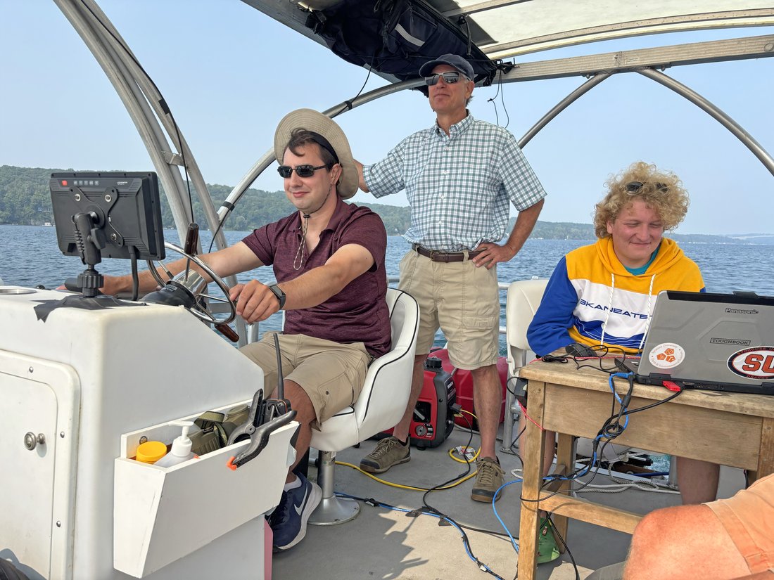 Nick Brennan, Chris Scholz and Jack Arnstein research on boat