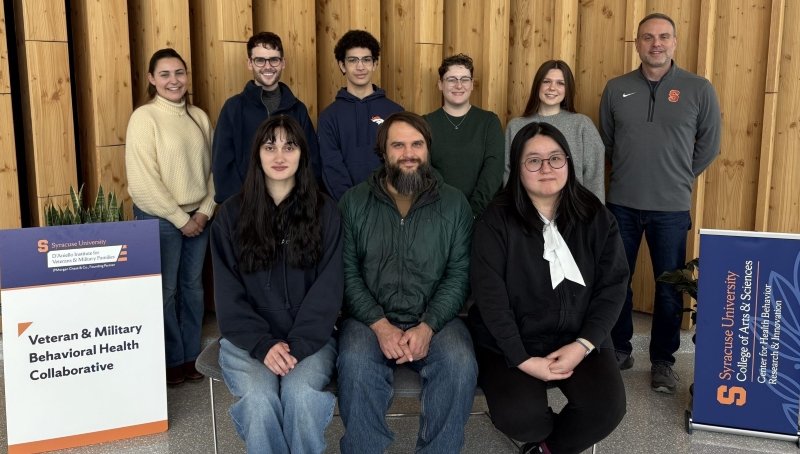 Group of people seated and standing.