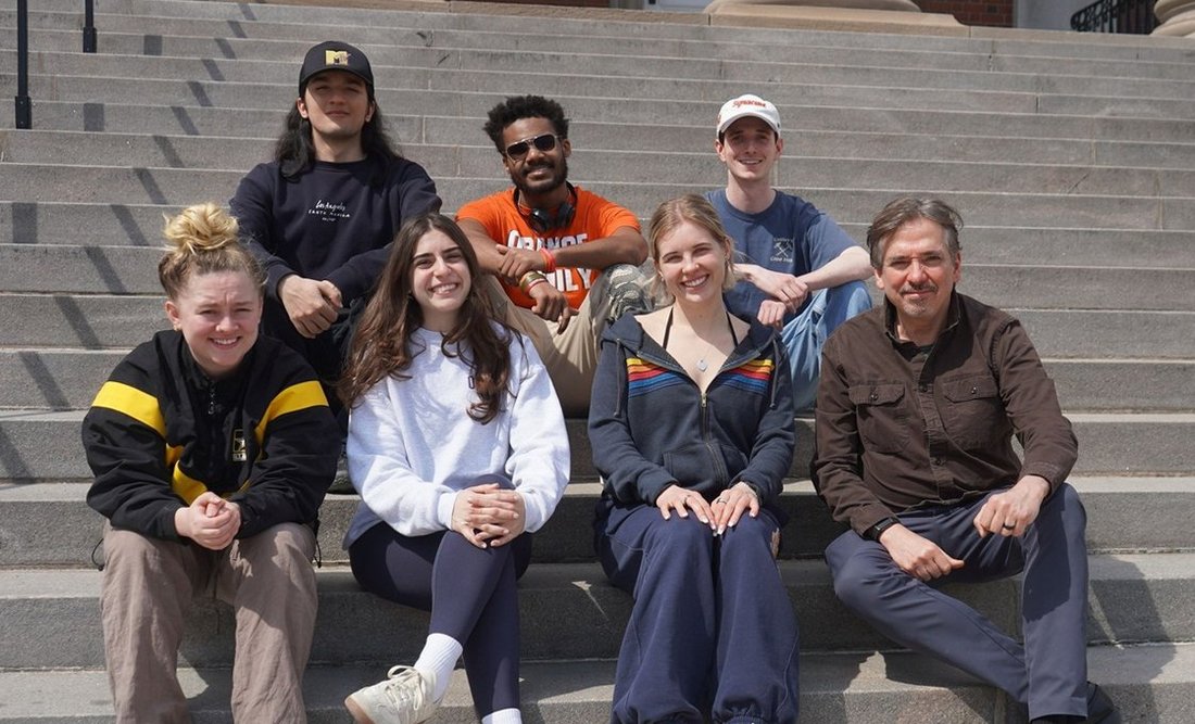 A group of people sitting on steps.