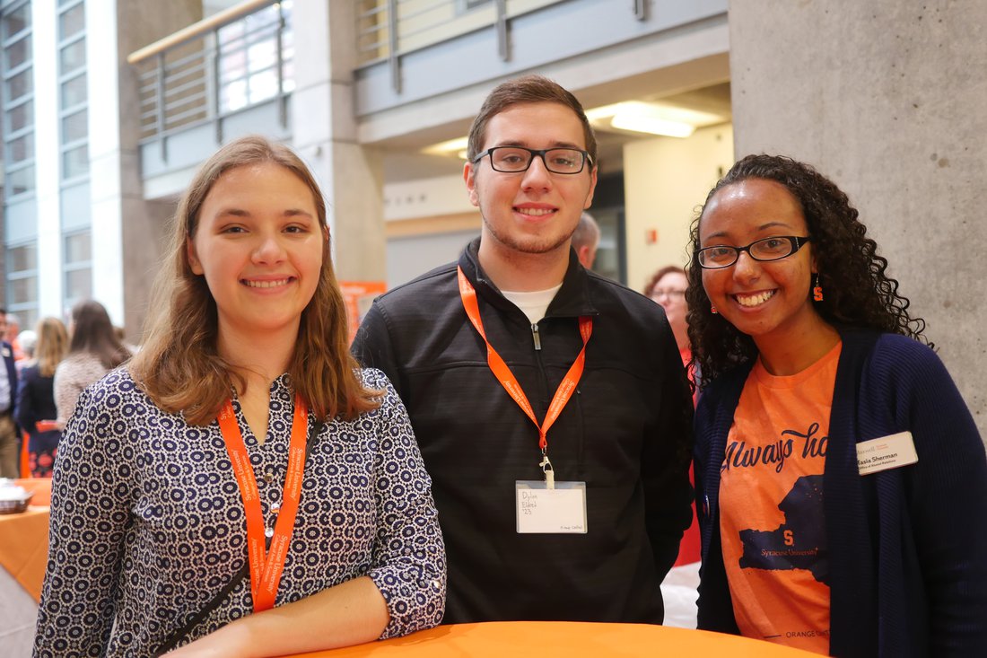 Three people standing together.