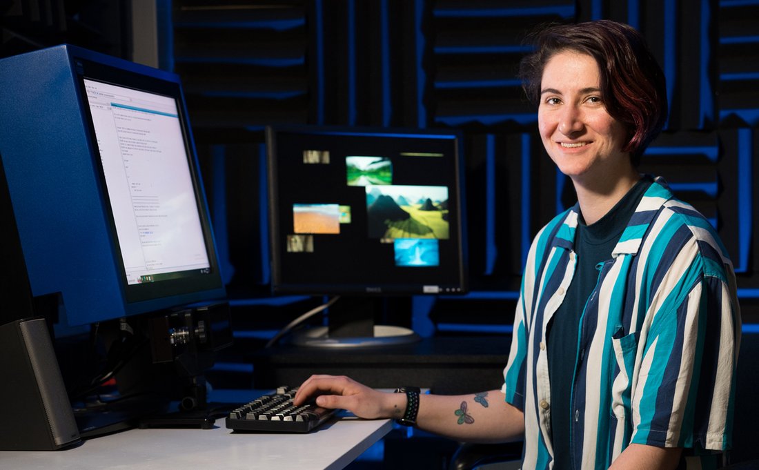Chloe Britton Naime sitting at a computer in the lab.