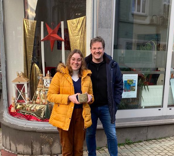 Courtney Conte ’23 (left) and Bochum town archivist Andreas Froning (right) with the Stolperstein, or stumbling stone, honoring Holocaust survivor Bob Hyman.