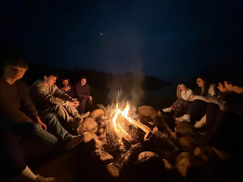 Group of people around a campfire.