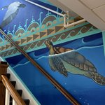 Wall mural of a turtle swimming.