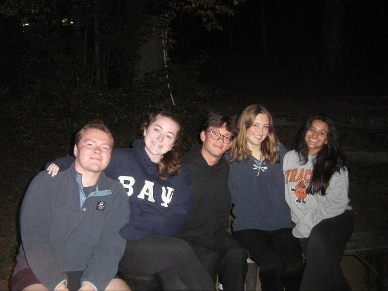 Group of students seated on a bench.
