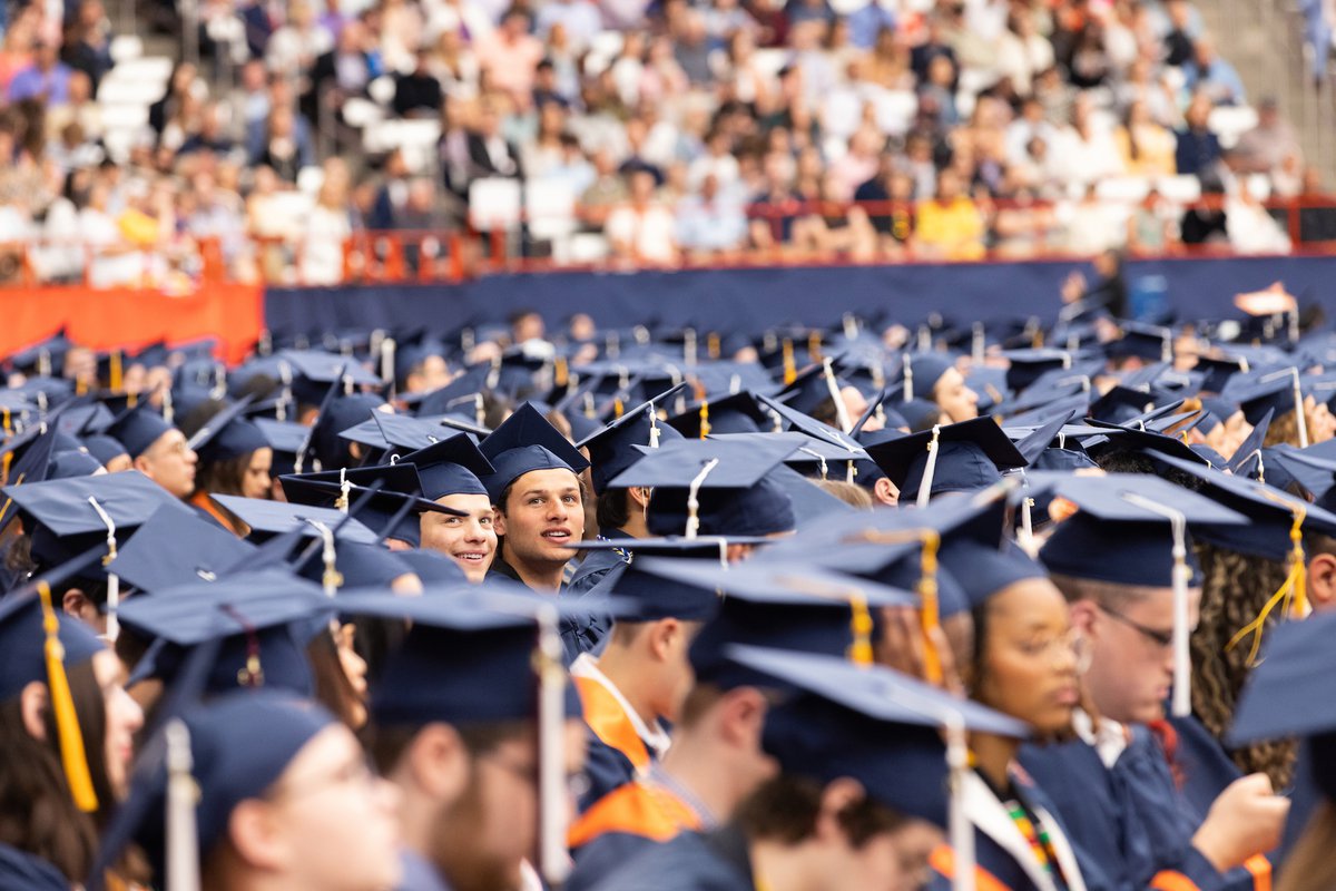 A sea of students sitting in their caps and gowns, anticipating walking across the stage to receive their hard-earned diploma.