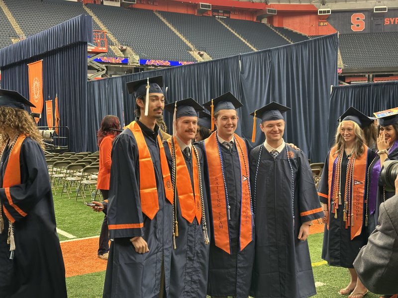 Four graduates posing for a photo.