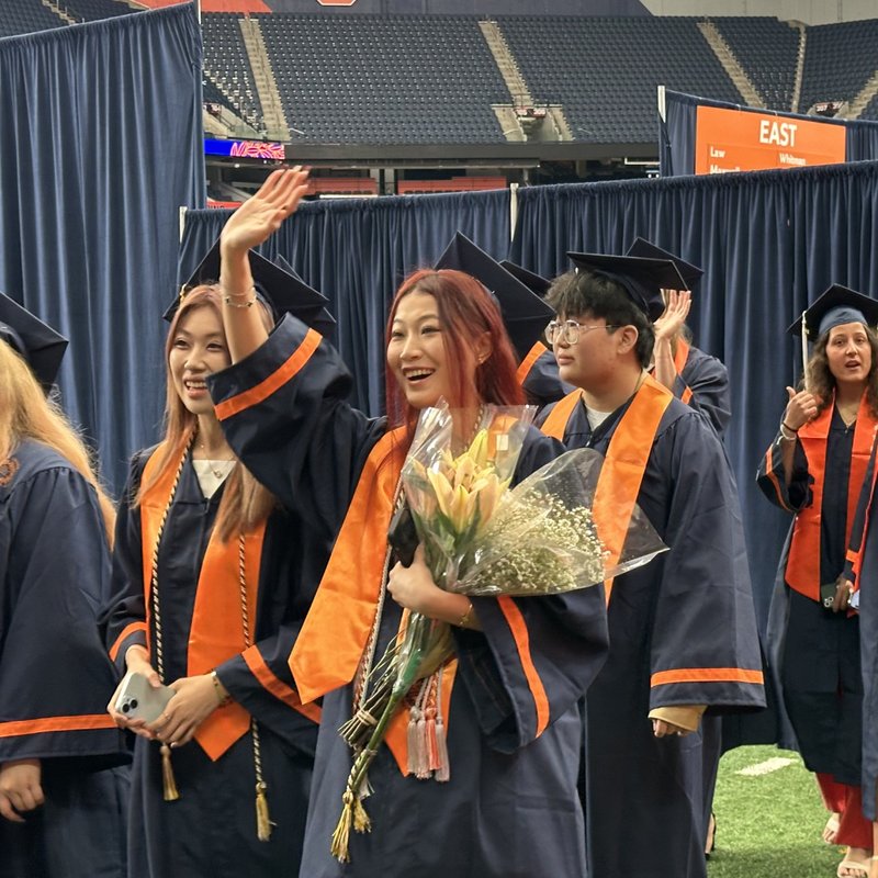 Graduate waving.