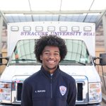 Man standing in front of an ambulance.