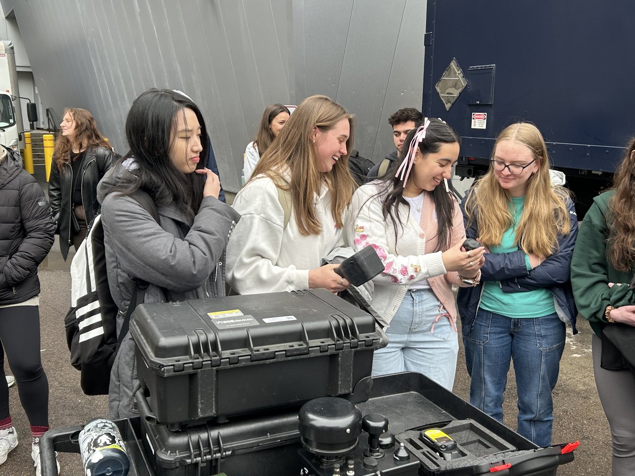 Students examining investigative equipment.