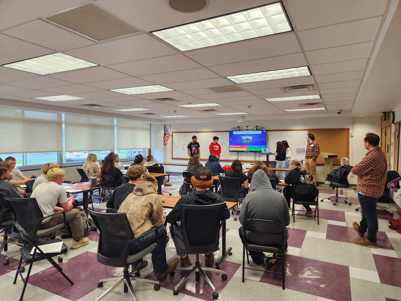 Group of students presenting to a class.