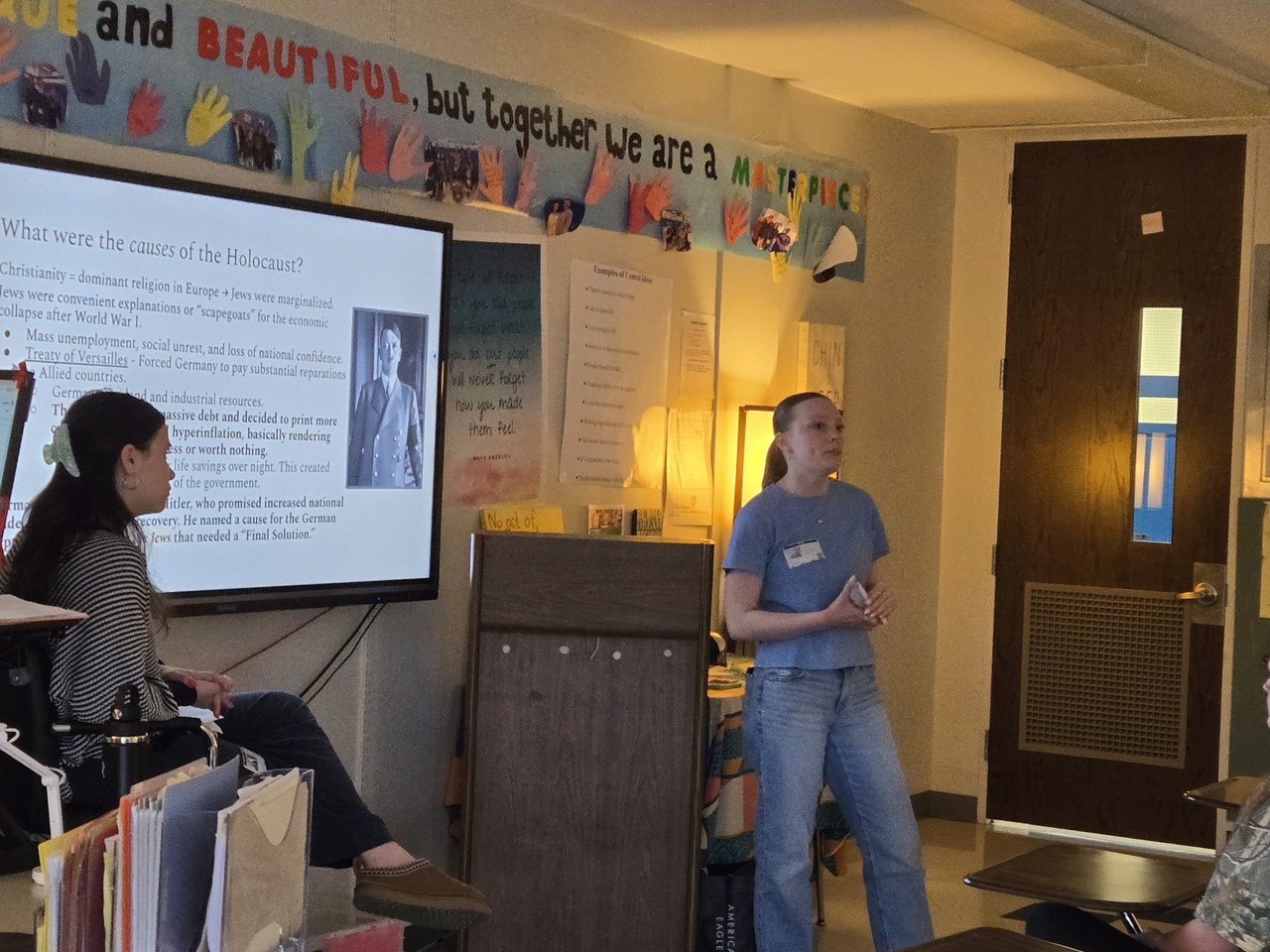 A student addressing a classroom of students.