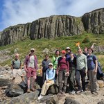 Group of people in front of the volcanic rocks of Drumadoon.