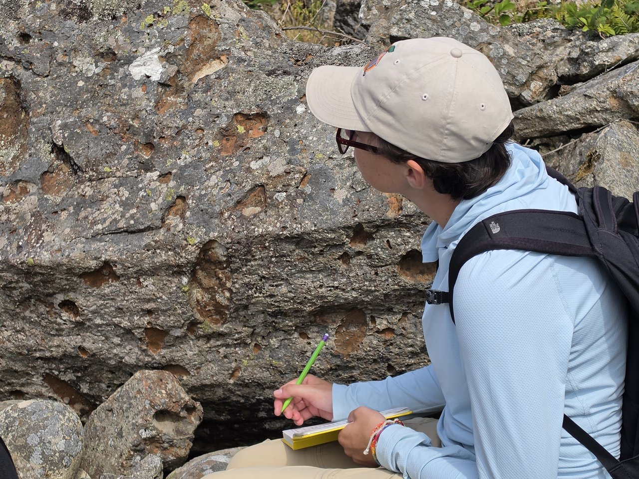 Person documenting rock features.