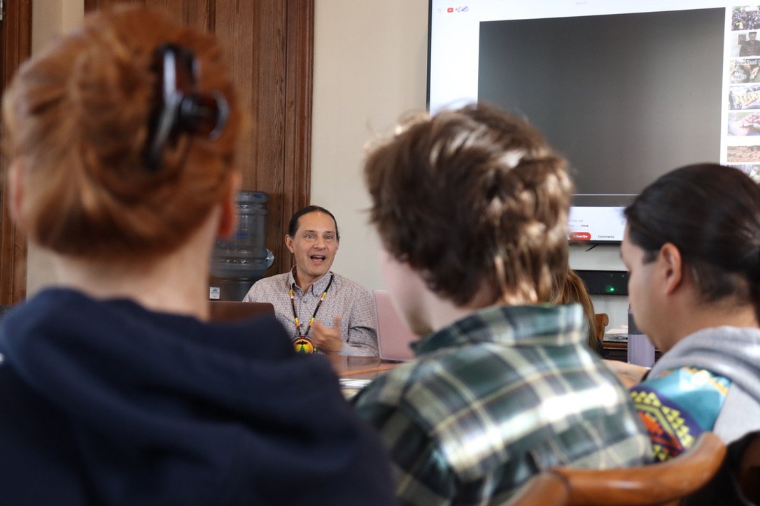 Filmmaker Jason Corwin leading storytelling workshop in crowded room