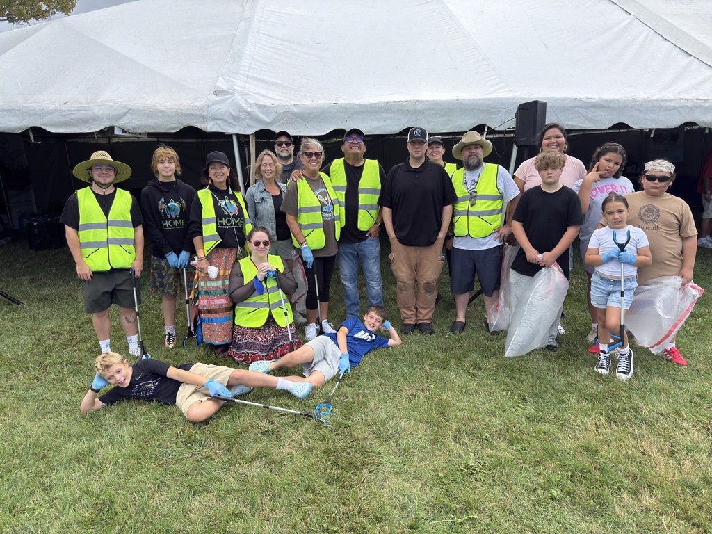 Group of people with cleaning equipment.