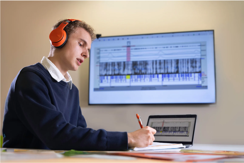 Student wearing headphones studying