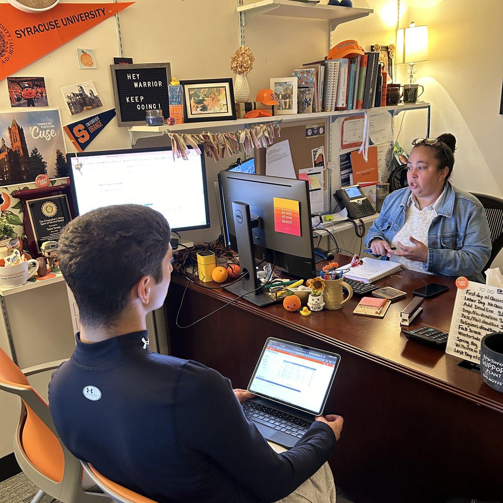 Two people having a conversation in an office.