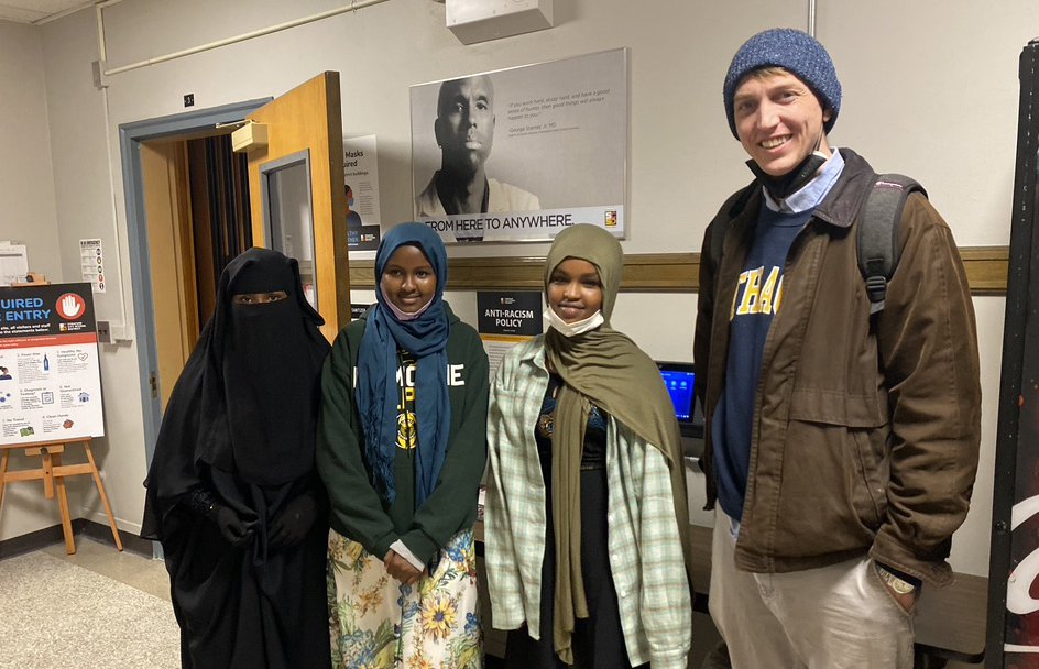 Graduate Student Andrew Ridgeway with high school students at local school board meeting