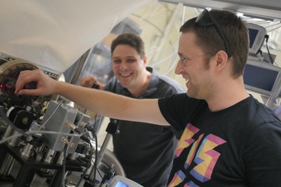 Ballmer (right) works with a student in his Syracuse University lab. 