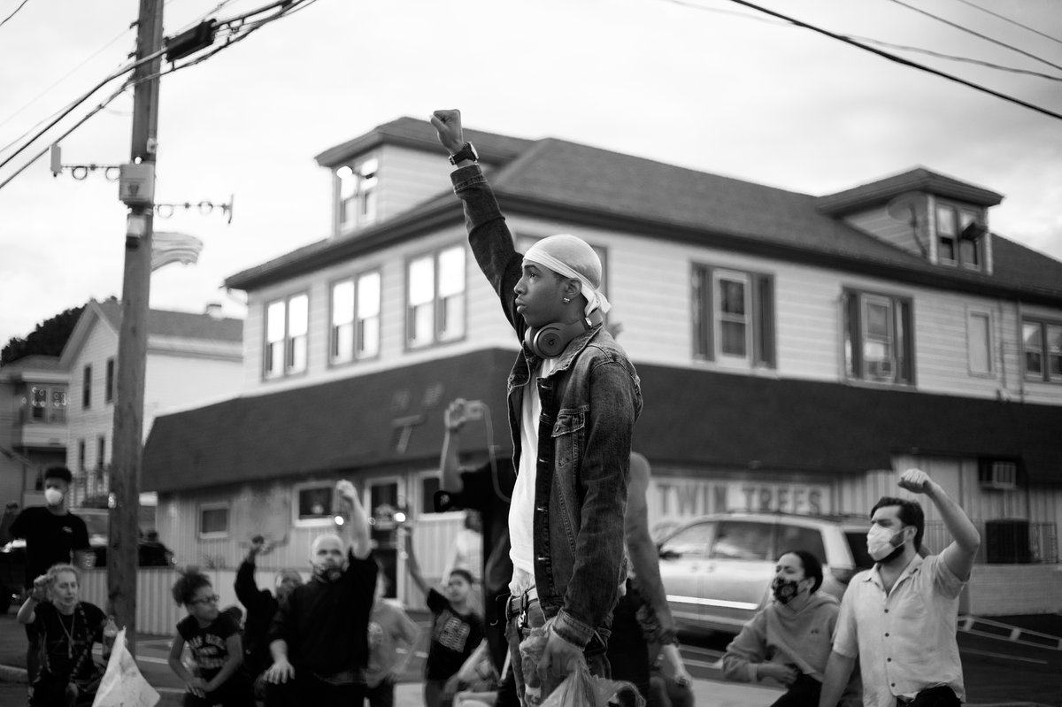 Man leading a march in the street with fist in the air