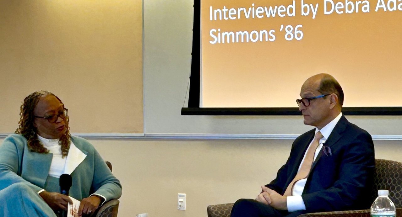 Two people seated having a discussion.