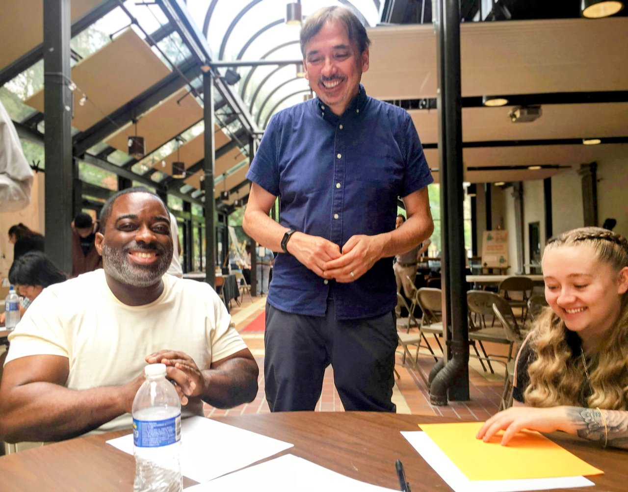 Patrick Berry, Marvin Wade and Alexis Kirkpatrick around a table.