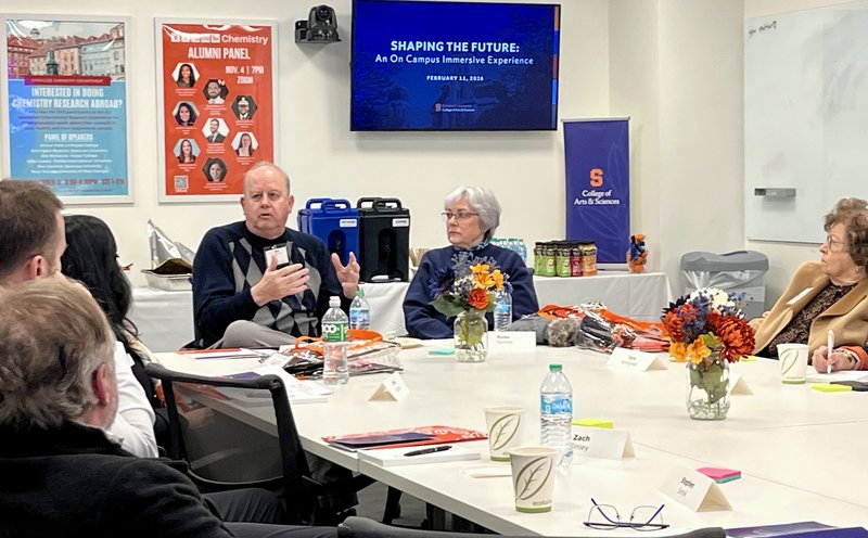 Man addressing a room of people.