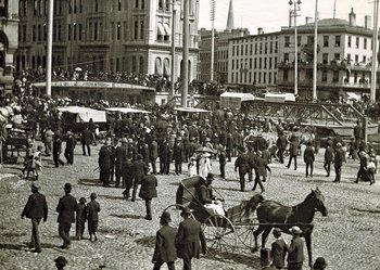 Historical photo of Erie Canal running through Clinton Square with people and horses lingering around.