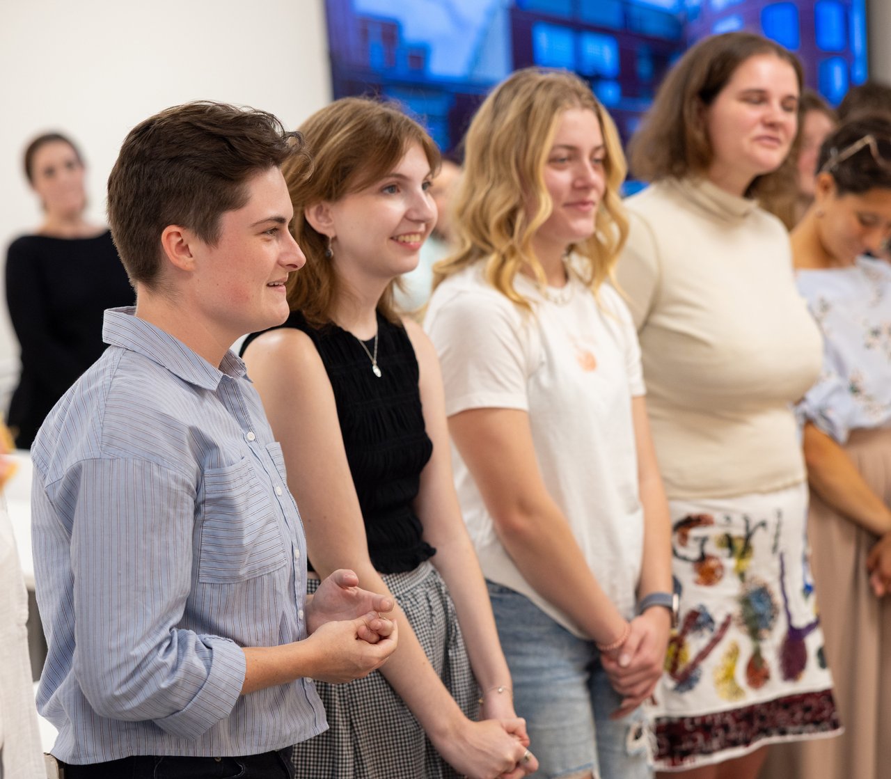 Group of people standing in a row.