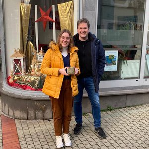 Courtney Conte ’23 (left) and Bochum town archivist Andreas Froning (right) with the Stolpersteine, or stumbling stone, honoring Holocaust survivor Bob Hyman.