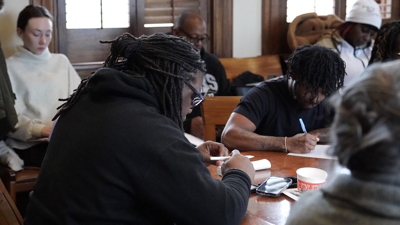 People seated at a table during a workshop.