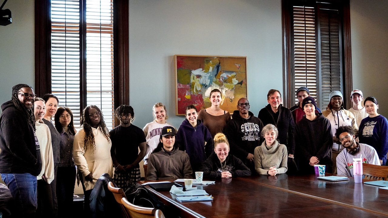 Group of people posing for a photo in a room.