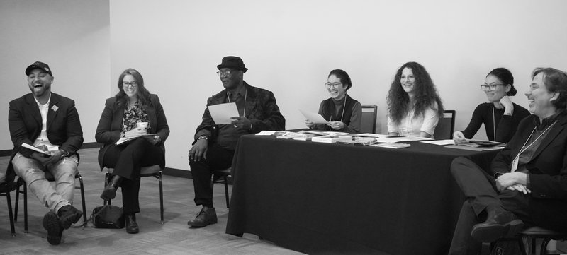 Group of people seated in a semi circle.