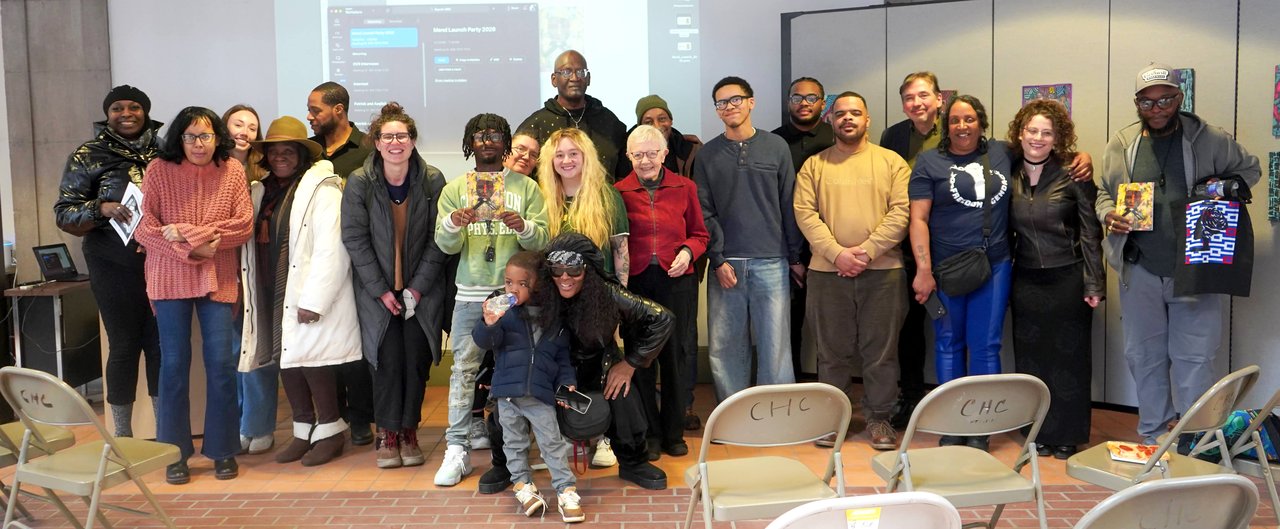 Group of people standing together in a room.
