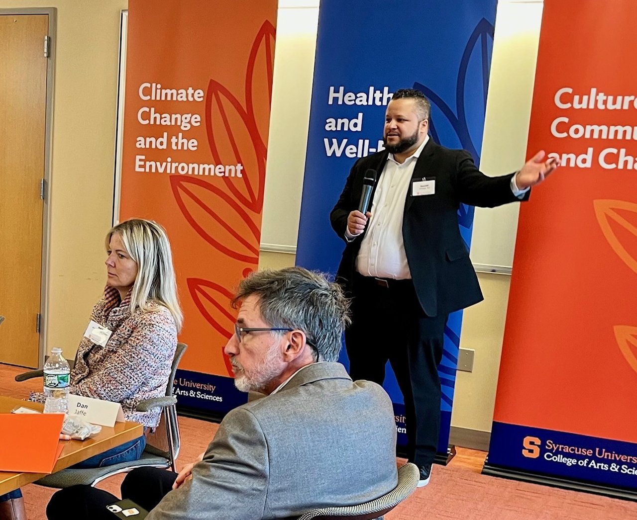 Person giving a presentation to a room of people.