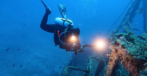 Diver examining a shipwreck.