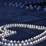 Two rows of candles formed into the shape of a heart.